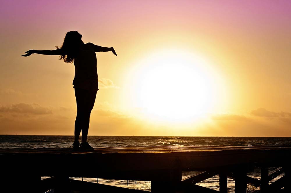 Female-Sunset Girl standing and looking up at the sunset, Edible Bike Tours, Spain